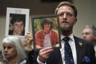 People hold photos of their loved ones as they sit in the audience before the start of a Senate Judiciary Committee hearing with the heads of social media platforms on Capitol Hill in Washington, Wednesday, Jan. 31, 2024, to discuss child safety. (AP Photo/Susan Walsh)