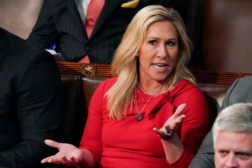 Rep. Marjorie Taylor Greene, a Republican of Georgia, talks as President Joe Biden delivers his first State of the Union address.