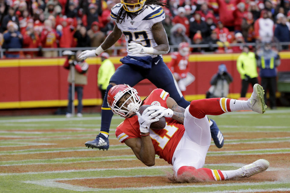 Kansas City Chiefs wide receiver Demarcus Robinson (11) makes a touchdown catch in front of Los Angeles Chargers safety Rayshawn Jenkins (23) during the first half of an NFL football game in Kansas City, Mo., Sunday, Dec. 29, 2019. (AP Photo/Charlie Riedel)