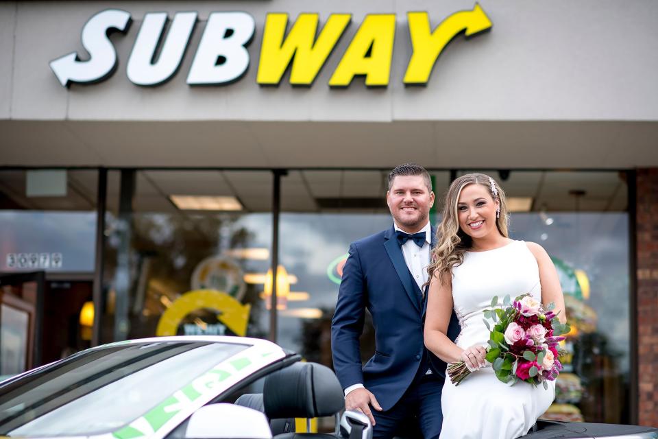 Julie Bushart &amp; Zack Williams pose outside of Subway Restaurant