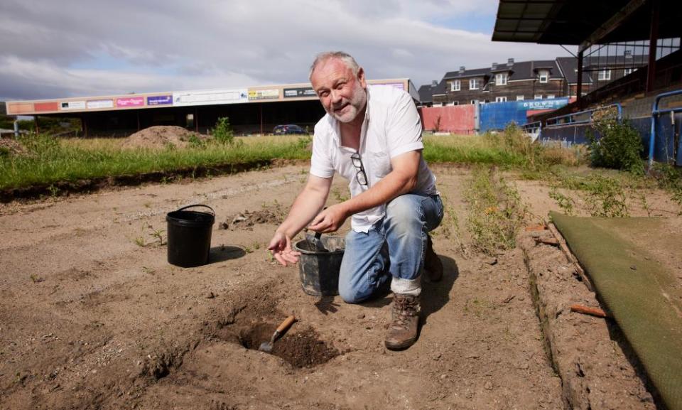 Jason Wood, archaeologist and heritage consultant on the project to memorialise the ground, searches for the ashes of fans buried underneath the pitch.