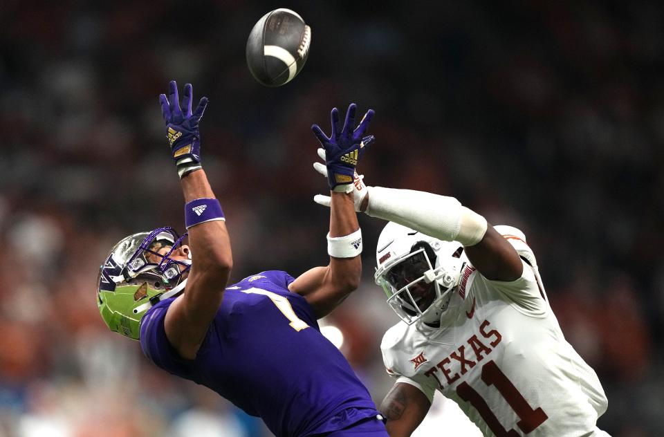 Washington wide receiver Rome Odunze can't come up with a catch as Texas defensive back Anthony Cook defends during the first half of Thursday night's Alamo Bowl at the Alamodome in San Antonio.