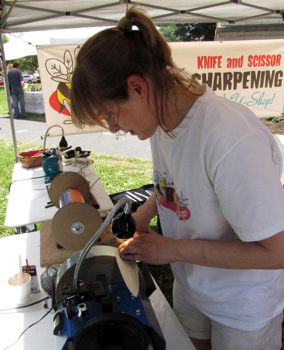 Sarah Spelbring of Bee Sharp will sharpen your knives while you shop at the Franklin St. Bazaar.