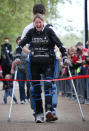 LONDON, ENGLAND - MAY 08: Claire Lomas crosses the finishing line of the Virgin London Marathon on May 8, 2012 in London, England. Ms Lomas, who is paralysed from the waist down after a riding accident in 2007, has taken 16 days to complete the 26.2 mile route. Starting out with 36,000 other runners she has averaged 2 miles a day with the help of a bionic ReWalk suit. (Photo by Peter Macdiarmid/Getty Images)