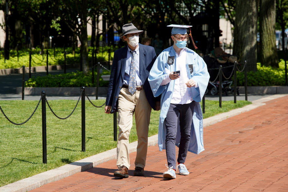 NEW YORK, NEW YORK - MAY 21:  A graduate wearing a cap, gown and protective face mask is seen on the campus of Columbia University on May 21, 2020 in New York City. COVID-19 has spread to most countries around the world, claiming over 332,000 lives with infections of over 5.1 million people. (Photo by Rob Kim/Getty Images)