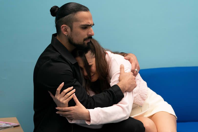 Ravi comforts Priya as their son is rushed to hospital in EastEnders