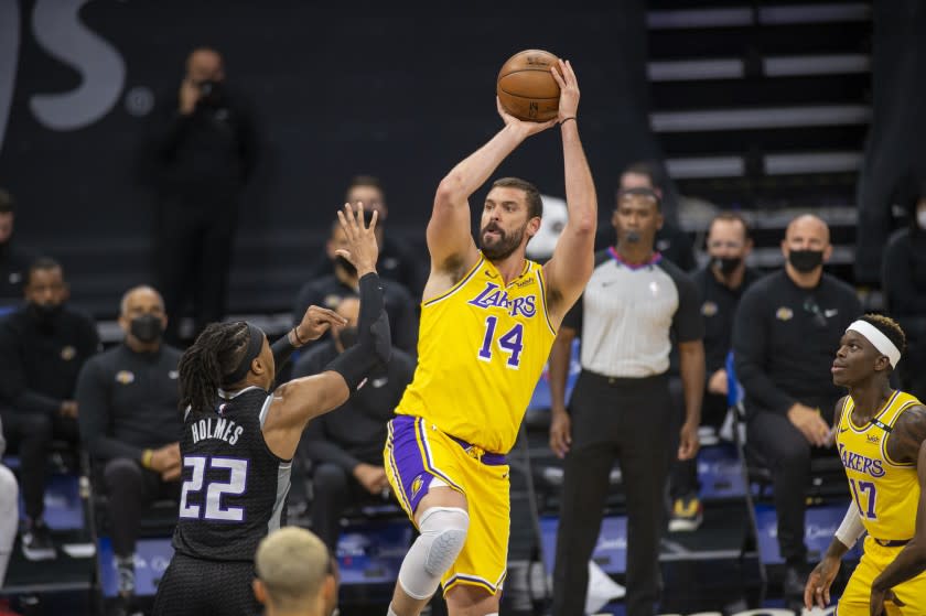 Los Angeles Lakers center Marc Gasol (14) shoots a basket as he is defended by Sacramento Kings center Richaun Holmes.