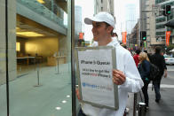 SYDNEY, AUSTRALIA - SEPTEMBER 21: A marketer promotes a brand in the queue the iPhone 5 at the Apple flagship store on George street on September 21, 2012 in Sydney, Australia. Australian Apple stores are the first in the world to receive and sell the new iPhone 5 handsets. (Photo by Cameron Spencer/Getty Images)