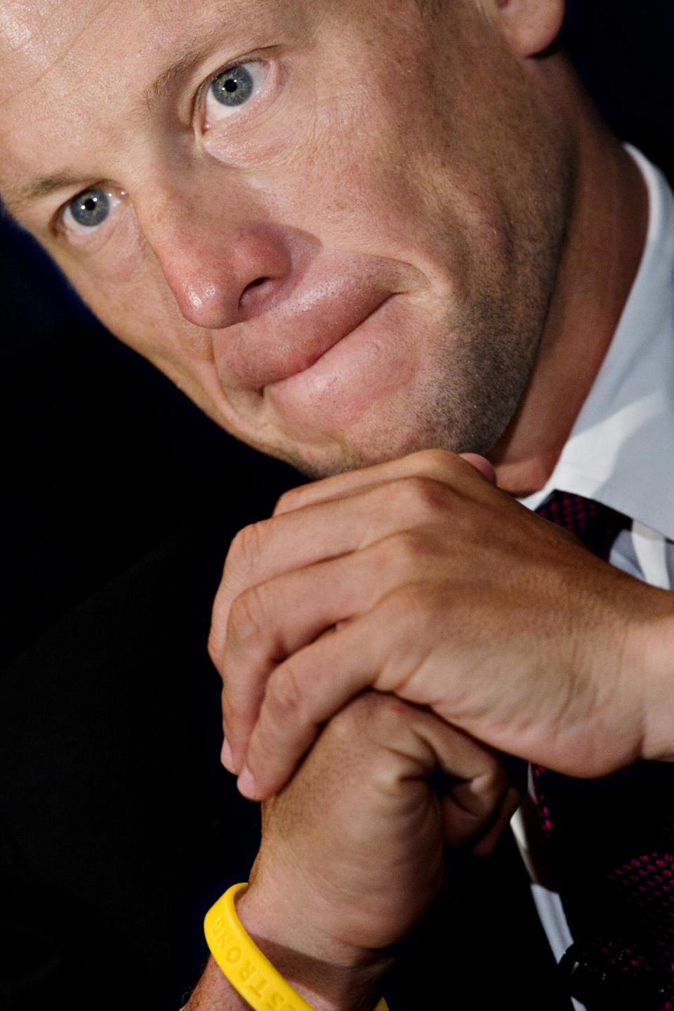 FILE - In this July 23, 2008, file photo, cyclist and cancer survivor Lance Armstrong wears a yellow Livestrong bracelet as he appears during a news conference regarding a new war on cancer at the National Press Club in Washington. Armstrong created the yellow "Livestrong" bracelets in 1997 after surviving stage three testicular cancer_with tumors that had spread to his abdomen, lungs, lymph nodes and brain_to raise funds for cancer research and later founded the Livestrong Foundation. Armstrong left the board of Livestrong in 2012 amidst doping accusations. (AP Photo/J. Scott Applewhite, File)