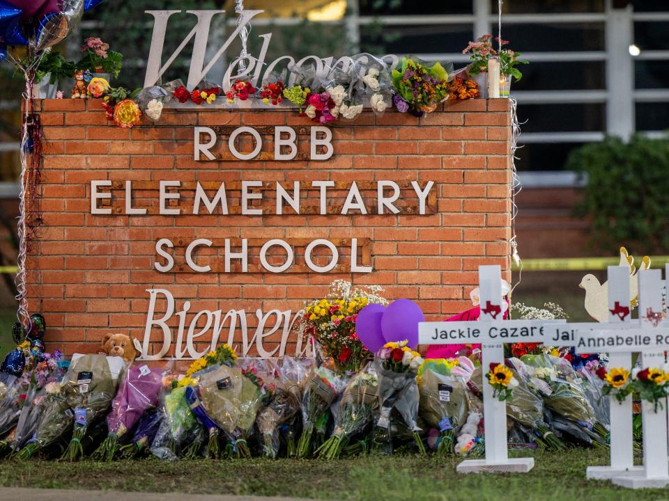 A memorial is seen surrounding the Robb Elementary School sign