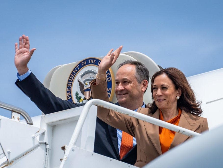 Vice President Kamala Harris and Second Gentleman Douglas Emhoff wave from Air Force Two