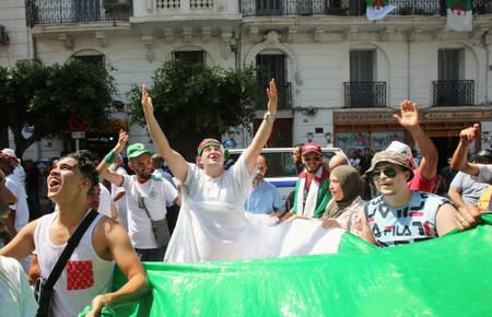 Demonstrators chant slogans during a protest demanding the removal of the ruling elite in Algiers