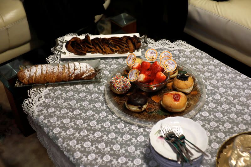 Sufagniyout, deep-fried doughnuts eaten during Hanukkah, the 8-day Jewish Festival of Lights, are placed on a table as the Shainfeld family gather to mark the holiday at Ramat Gan, Israel