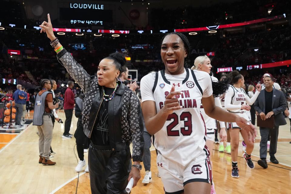 South Carolina head coach Dawn Staley and guard Bree Hall (23) celebrate after the Gamecocks defeated North Carolina State in a national semifinal on Friday at Rocket Mortgage FieldHouse,