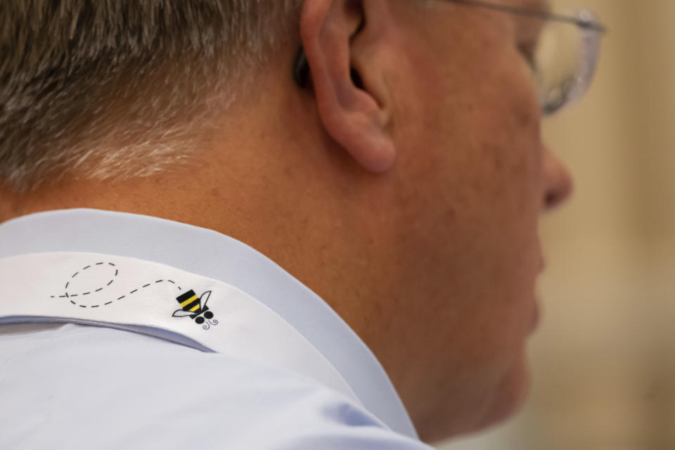 Associate Pronouncer Brian Sietsema wears a lanyard featuring a cartoon bee during a word panel meeting to finalize the 2023 Scripps National Spelling Bee words on Sunday, May 28, 2023, at National Harbor in Oxon Hill, Md. (AP Photo/Nathan Howard)
