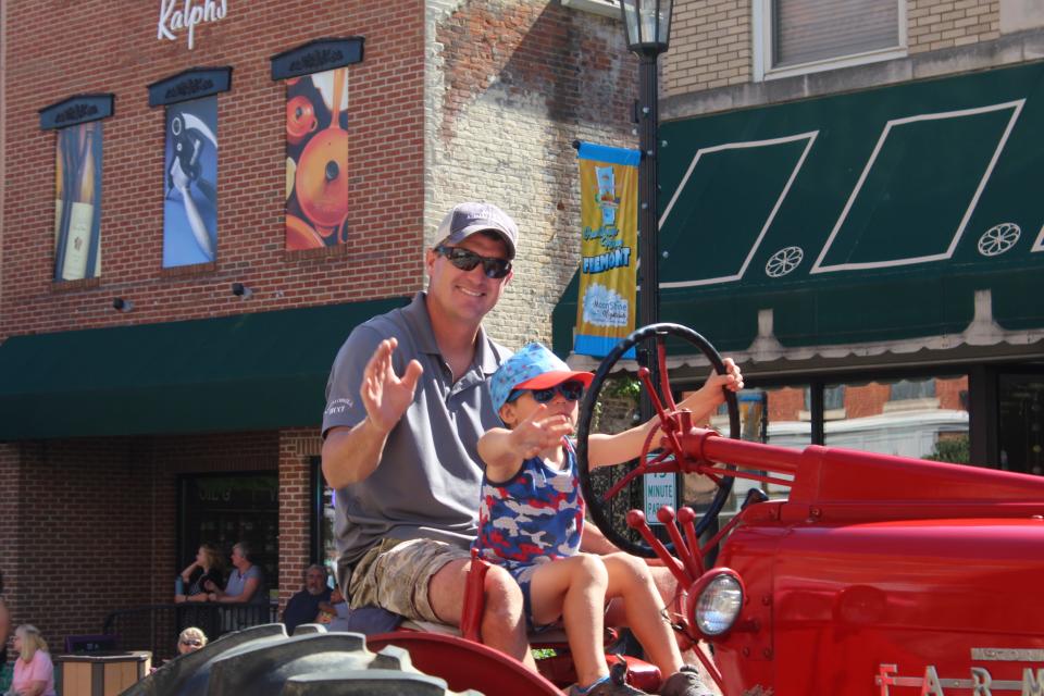 A tractor steered by drivers of different ages takes part in the Independence Day parade in Downtown Fremont on Saturday.