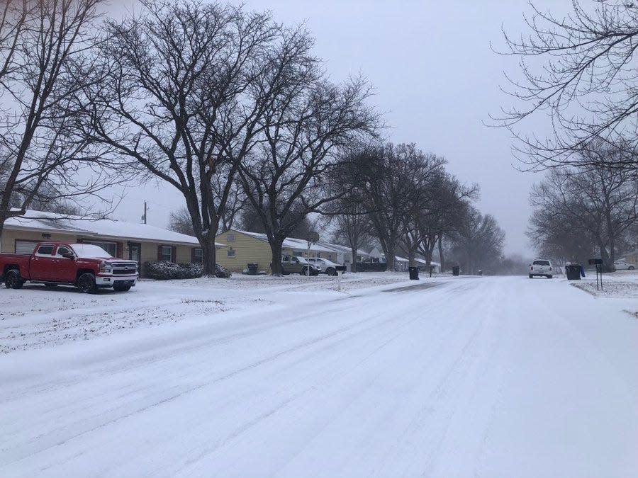 Light snow covered the street and the windshields of vehicles Thursday morning in the 1200 block of S.W. 32nd.