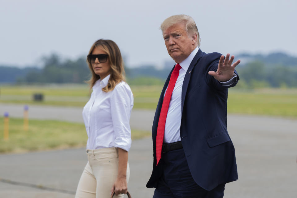 President Donald Trump and first lady Melania Trump, walk on the tarmac upon arrival at Morristown Municipal Airport, in Morristown, N.J., Friday, July 5, 2019. (AP Photo/Manuel Balce Ceneta)