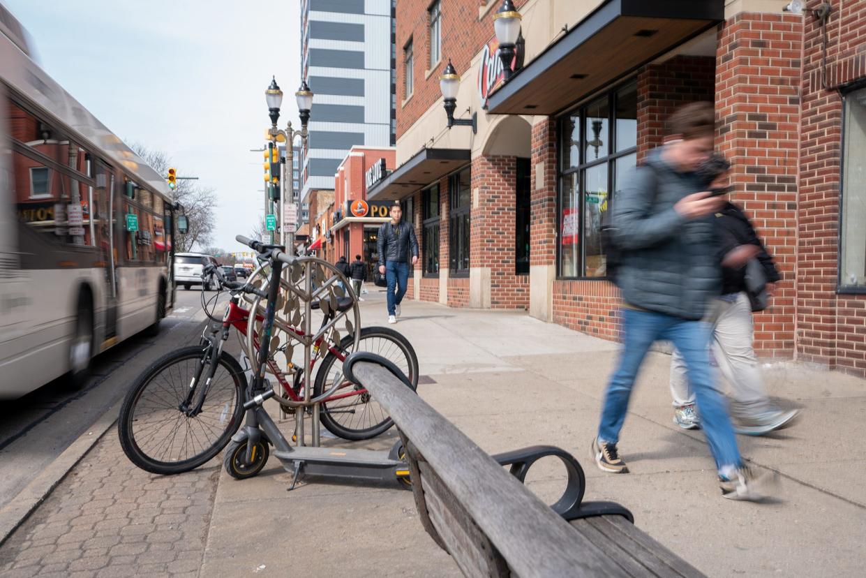 Pedestrians walk down the street in downtown East Lansing on Monday, March 25, 2024. This area boasts numerous restaurants and is intersected by several bus lines serving both the MSU campus and Lansing's capital area.