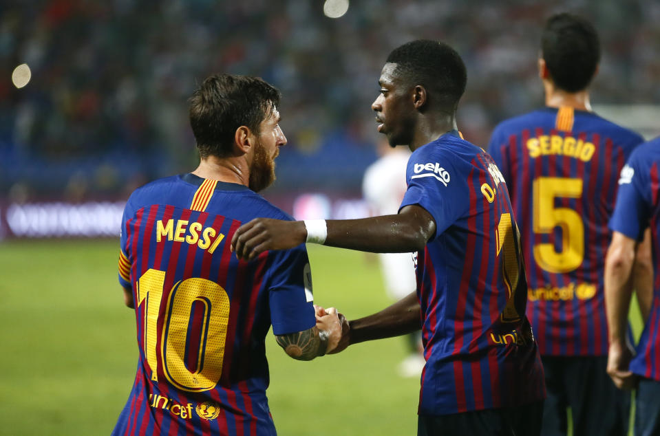 Barcelona's Ousmane Dembele celebrates with Lionel Messi, left, after scoring his side's second goal during the Spanish Super Cup soccer match between Sevilla and Barcelona in Tangier, Morocco, Sunday, Aug. 12, 2018. (AP Photo/Mosa'ab Elshamy)