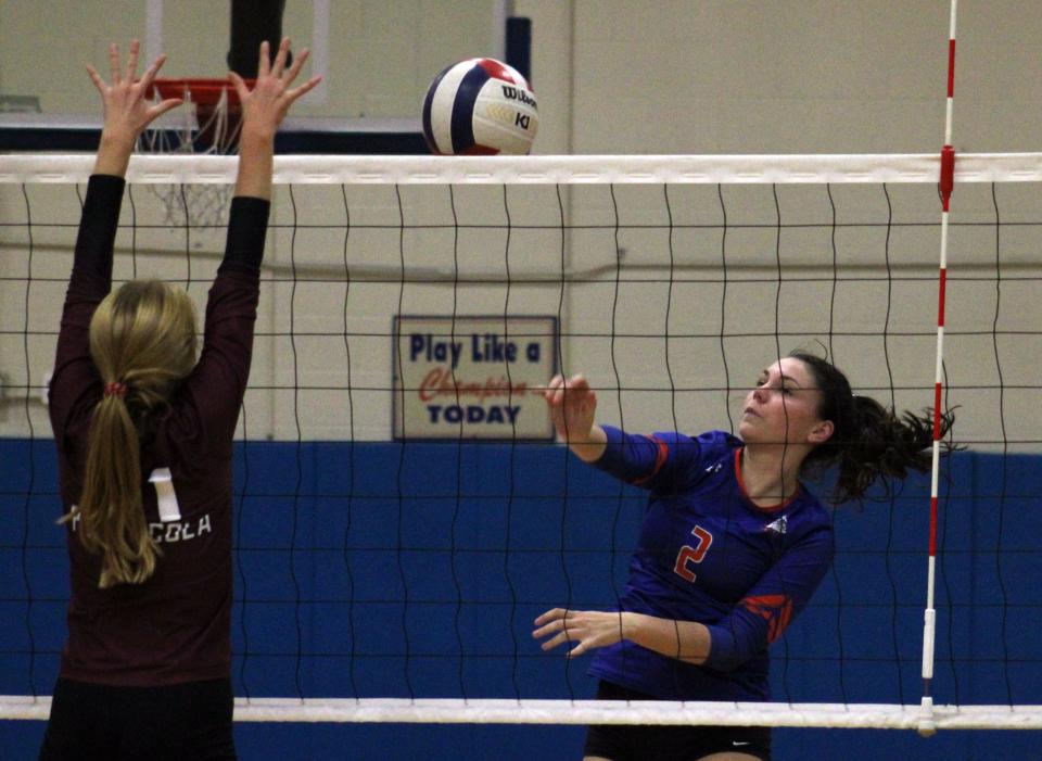 Bolles' Bella Bergeron (2) hits the ball as Pensacola's Emma Carroll (21) defends during an FHSAA Region 1-4A high school volleyball quarterfinal on October 25, 2022. [Clayton Freeman/Florida Times-Union]