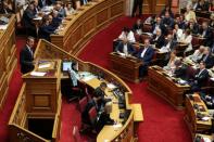 Greek PM Mitsotakis presents his government's main policies as Syriza party leader Tsipras looks on, during a parliamentary session in Athens