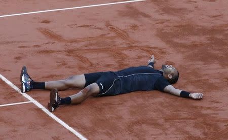 Jo-Wilfried Tsonga of France celebrates after defeating Kei Nishikori of Japan during their men's quarter-final match during the French Open tennis tournament at the Roland Garros stadium in Paris, France, June 2, 2015. REUTERS/Jean-Paul Pelissier