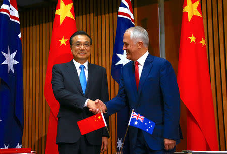 Australia's Prime Minister Malcolm Turnbull shakes hands with Chinese Premier Li Keqiang before the start of an official signing ceremony at Parliament House in Canberra, Australia, March 24, 2017. REUTERS/David Gray