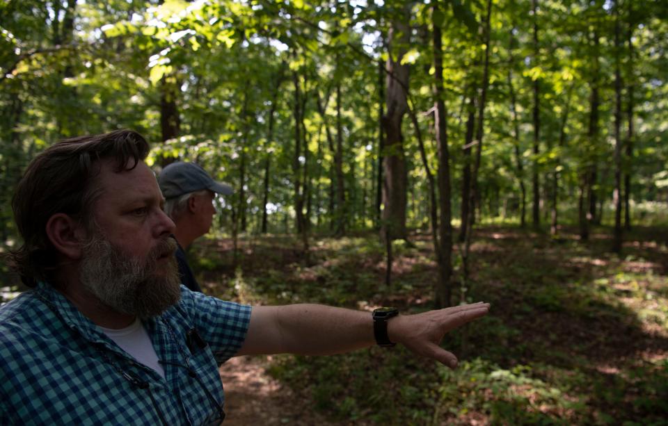 Elmer Mobley, points to where development will take place at  Bowie Nature Park in Fairview , Tenn., Thursday, May 12, 2022.