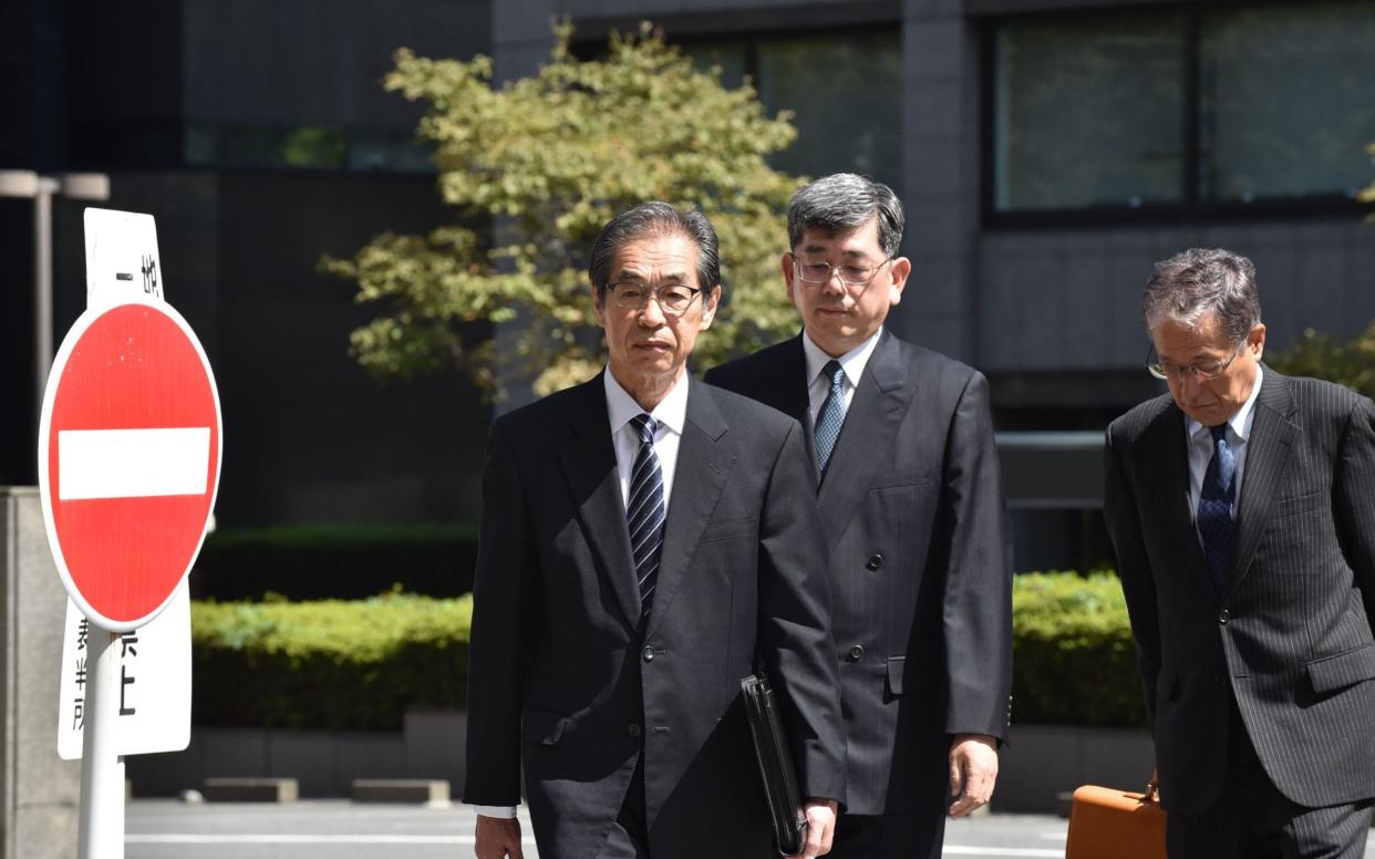 Ichiro Takekuro (L), former vice president of Tepco, arrives at the Tokyo District Court in Tokyo on September 19, 2019 - AFP