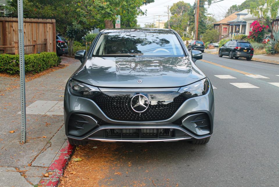 A gray Mercedes SUV parked on a street. 