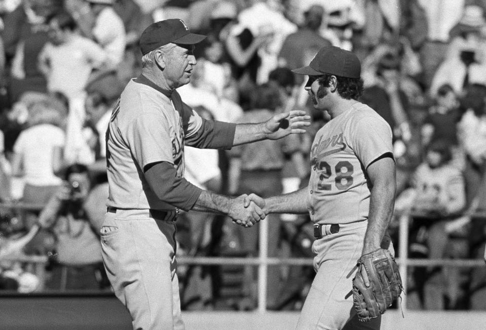 FILE - In this Oct. 6, 1974, file photo, Los Angeles Dodgers manager Walt Alston, left, congratulates relief pitcher Mike Marshall after the Dodgers defeated the Pittsburgh Pirates 5-2 in Game 2 of the NL Championship Series in Pittsburgh. Marshall, who became the first reliever to win the Cy Young Award while pitching for the Dodgers and eight other major league teams in both leagues, has died. Marshall, 78, died Monday night, May 31, 2021, in Zephyrhills, Fla., according to the Dodgers, who spoke Tuesday to his daughter, Rebekah. She said he had been in hospice care, but did not give a cause of death. (AP Photo, File)