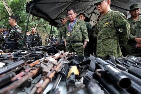 Philippine President Rodrigo Duterte inspects firearms together with Eduardo Ano, Chief of Staff of the Armed Forces of the Philippines (AFP), during his visit at the military camp in Marawi city, southern Philippines July 20, 2017. Malacanang Presidential Palace/Handout via Reuters