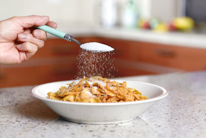 spoonful of sugar being sprinkled over cereal