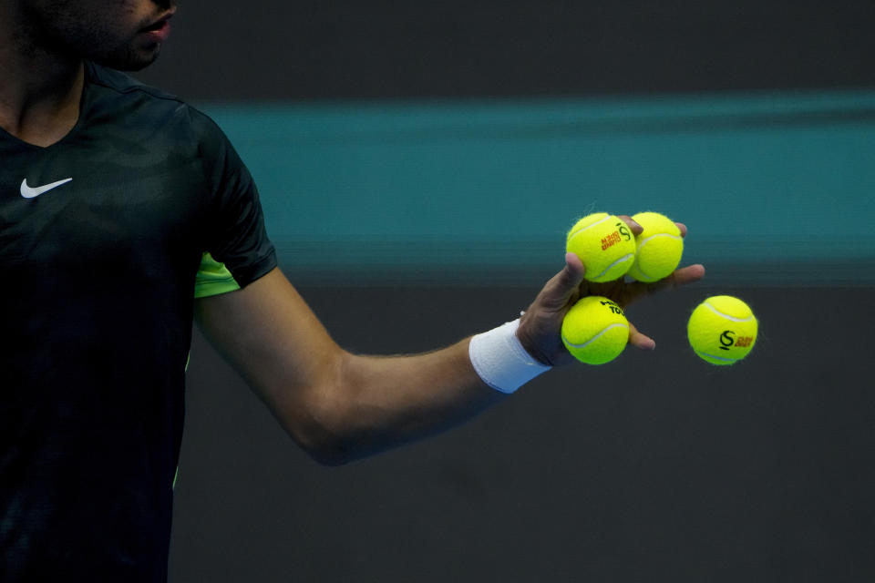 Carlos Alcaraz of Spain catches the ball as he preparing to serve against Lorenzo Musetti of Italy during the second round of the men's singles in the China Open tennis tournament at the Diamond Court in Beijing, Sunday, Oct. 1, 2023. (AP Photo/Andy Wong)