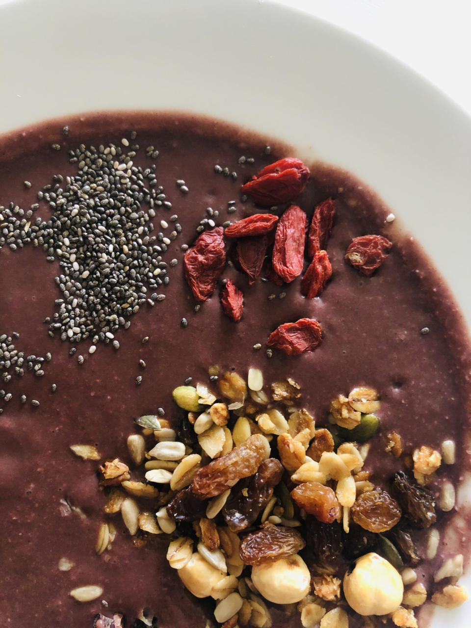 Açai bowl topped with chia seeds, granola and goji berries.