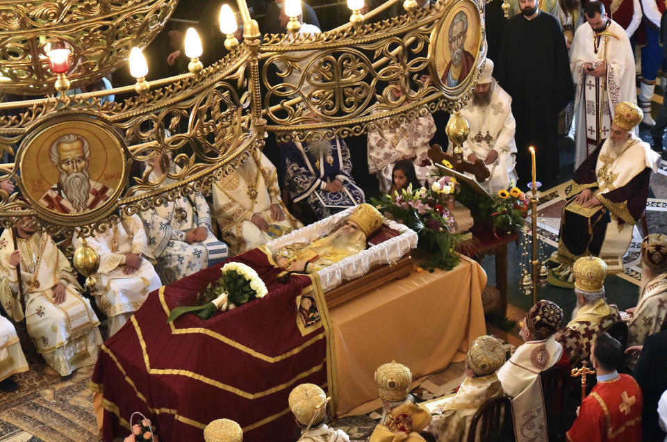 An open casket with Bishop Amfilohije's body during the liturgy and funeral in the main temple in the capital Podgorica, Montenegro, Sunday, Nov. 1, 2020. Bishop Amfilohije died on Friday after contracting the coronavirus weeks ago. A mass funeral on Sunday was held for the popular head of the Serbian Orthodox Church in Montenegro in violation of restrictions that are in place against the new coronavirus. (AP Photo/Risto Bozovic)