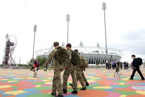 British military personnel walk past the Olympic Stadium ahead of the London 2012 Olympic Games in the Olympic Park in east London. The head of private security giant G4S admitted the company's failure to provide enough guards for the Olympics was "a humiliating shambles" as he faced a grilling from British lawmakers Tuesday