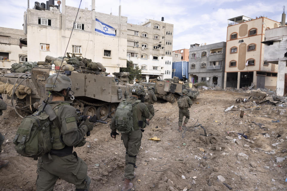 FILE - Israeli soldiers walk in Gaza City's Shijaiyah neighborhood on Dec. 8, 2023, as part of an operation to round up hundreds of Palestinians across the northern Gaza Strip and truck some to an undisclosed location. (AP Photo/Moti Milrod, Haaretz, File)