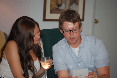 The happy couple opening their gifts together.