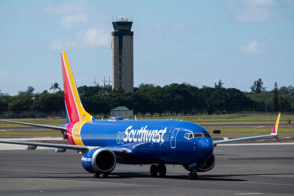 Southwest Max 8 in Honolulu with the ATC tower in background.