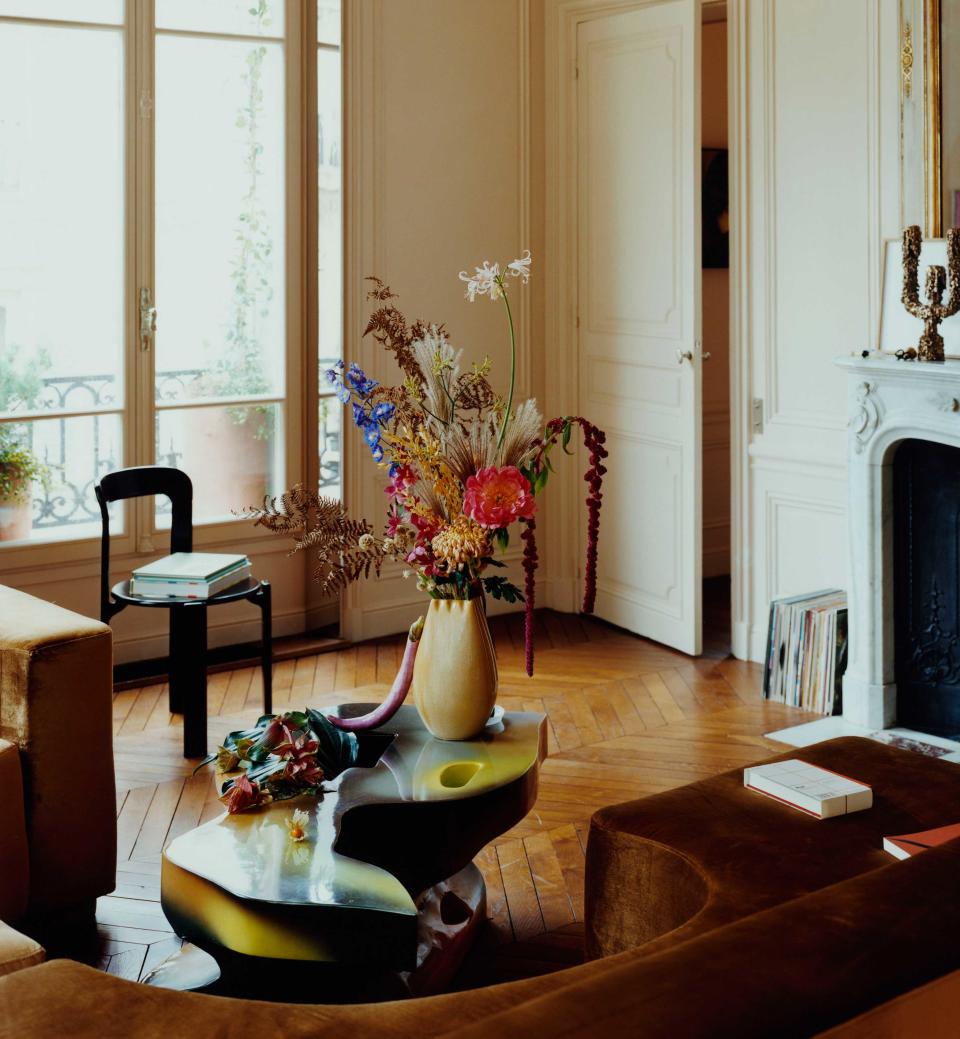 a modern coffee table with a big vase of flowers