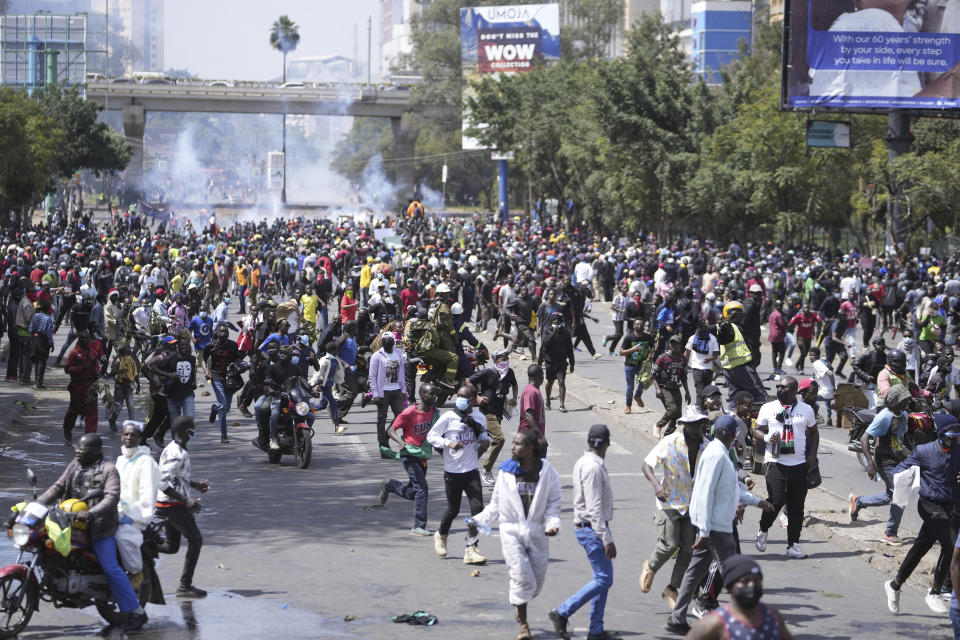 Protesters scatter as Kenya police spray water canon at them during a protest over proposed tax hikes in a finance bill in downtown Nairobi, Kenya Tuesday, June. 25, 2024. (AP Photo/Brian Inganga)