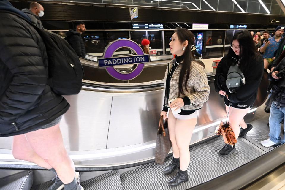 People take part in the annual &#39;No Trousers On The Tube Day&#39; (No Pants Subway Ride) on the London Underground in central London on January 8, 2023. - 2023 sees the 12th annual No Trousers Tube Ride in London. The day is now marked in over 60 cities around the world. The idea behind 