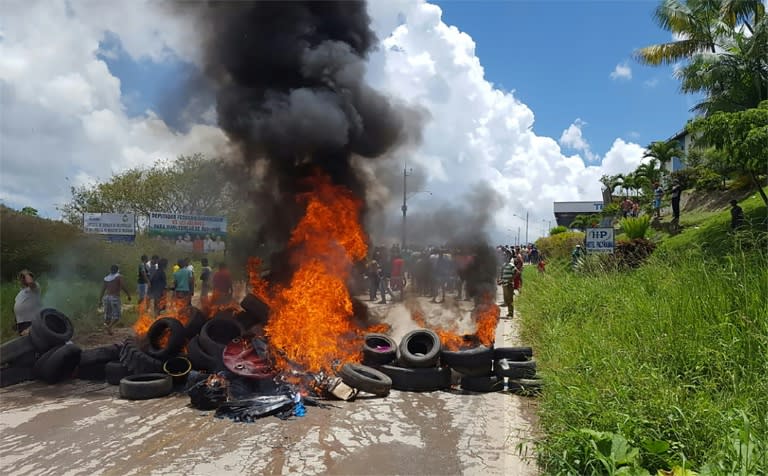 Residents of the Brazilian border town of Pacaraima burn tyres and belongings of Venezuelans immigrants after attacking their makeshift camps and forcing them back across the border on August 18, 2018