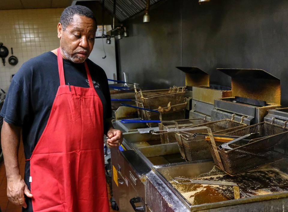 Ed Burtley, manager at Gregory's Soul Food in Lansing also cooks to cut down on staffing at the popular restaurant Saturday, May 2, 2020.