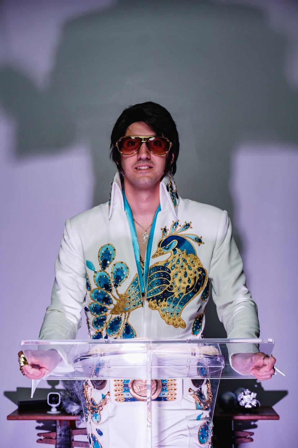Michael Brindley, pastor of Organic Church in Uhrichsville, poses in an exact replica of the peacock jumpsuit worn by Elvis Presley. He puts on Elvis shows, and from time to time interjects faith teachings into those shows.