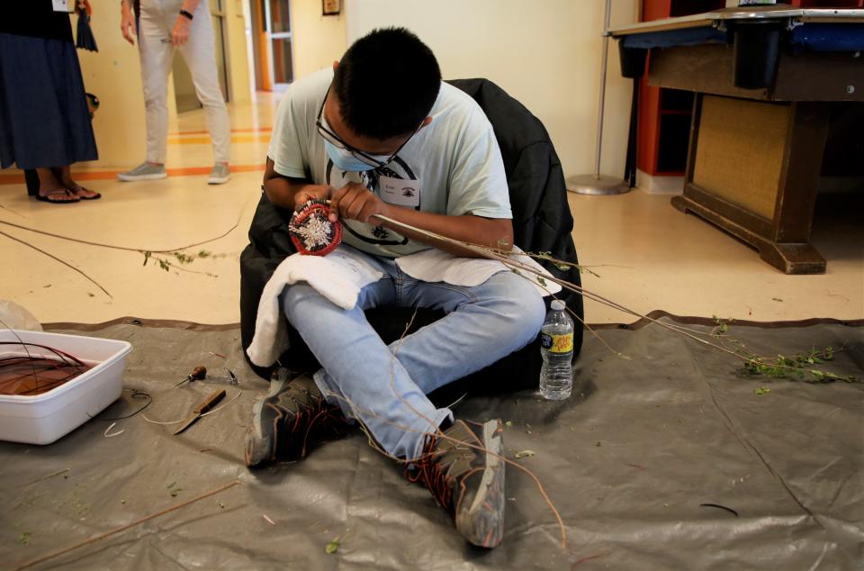 Evan Stephenson works on his Navajo ceremonial basket at Dahayoigii A Youth Art Event 2022 on July 13 at the Shiprock Youth Complex.