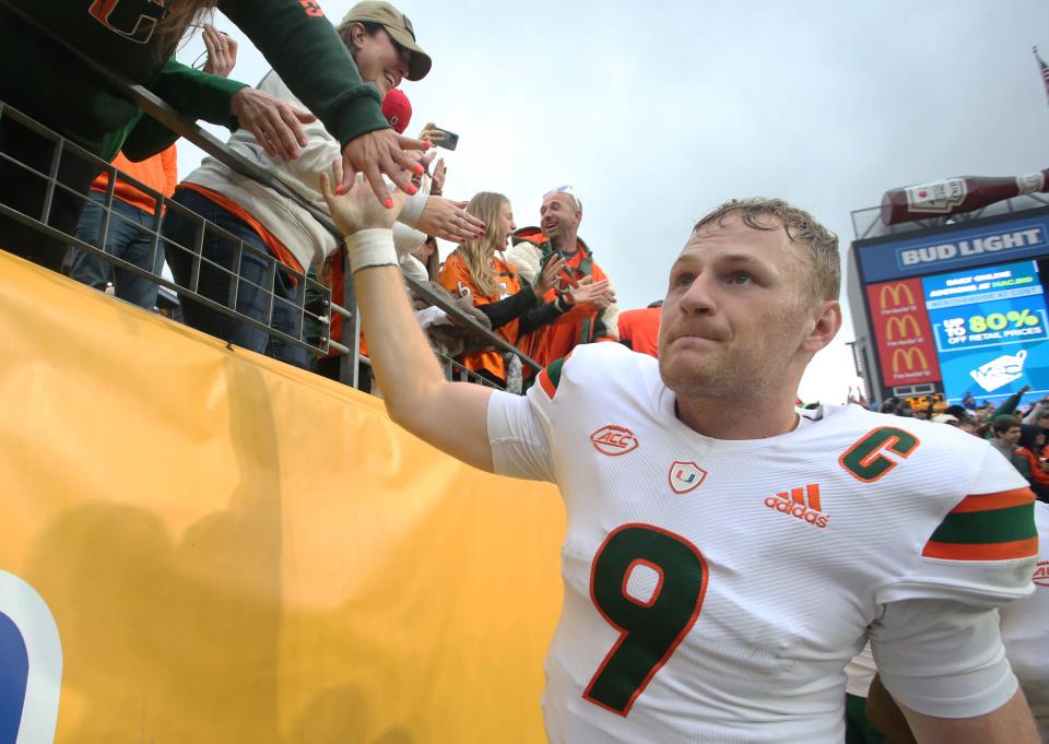 Oct 30, 2021; Pittsburgh, Pennsylvania, USA;  Miami Hurricanes quarterback Tyler Van Dyke (9) celebrates with fans after defeating the Pittsburgh Panthers at Heinz Field. Miami won 38-34. Mandatory Credit: Charles LeClaire-USA TODAY Sports