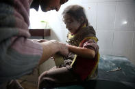 <p>A Syrian child receives treatment at a makeshift hospital following reported Syrian air force strikes in the rebel-held town of Hamouria, in the besieged Eastern Ghouta region on the outskirts of the capital Damascus on Feb. 8, 2018. (Photo: Abdulmonam Eassa/AFP/Getty Images) </p>